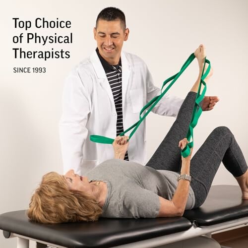 Physical therapist assisting woman with leg exercises using resistance band.